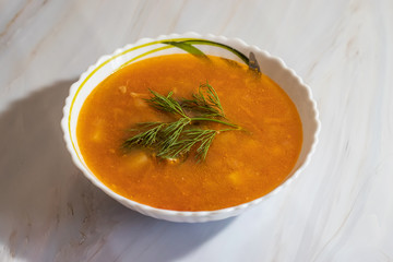 Veggie pea soup with carrots and dill on a white background