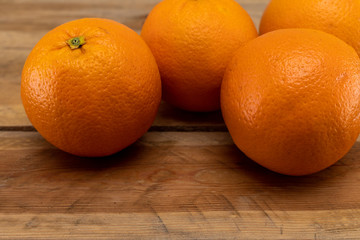 Oranges on a wooden table.