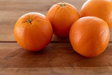 Oranges on a wooden table.