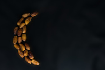 Dried dates on black background.