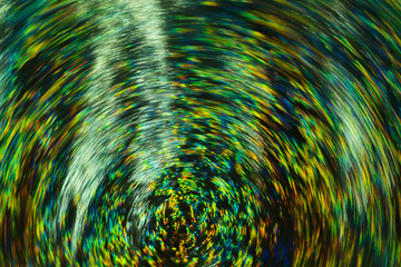 Neon lights on dark background. Whirling multicolor defocused lines. Lens flare. Blurred abstract...