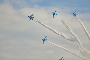 Blue fighter jets flying in formation