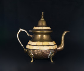 Vintage kettle on black background.