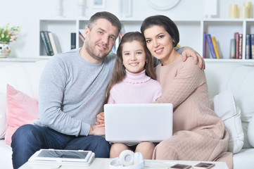 Fototapeta premium Happy family with laptop