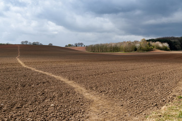 Nottinghamshire Landscape on a dramatic Springtime afternoon views and footpath across plowed fields 