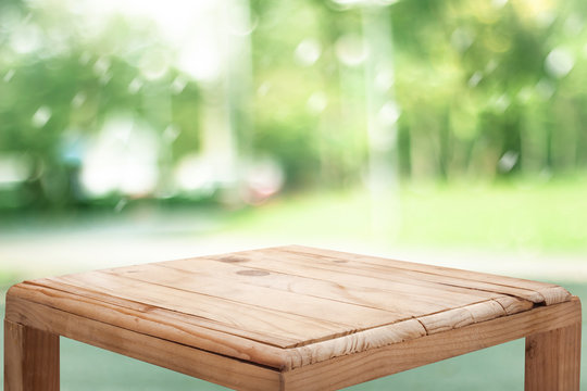 empty wooden on blurred nature backdrop. Wood table top. can used for display or montage your products
