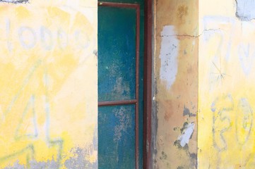 Blue steel door and a yellow wall background (Ari Atoll, Maldives)
