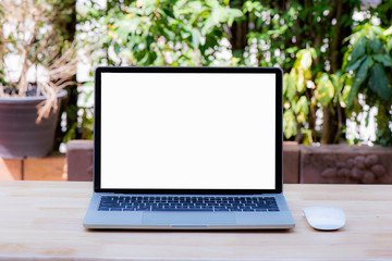 Laptop with blank screen And wireless mouse at blurred background nature of light bokeh