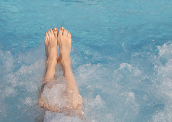 feet of young woman during the whirlpool therapy