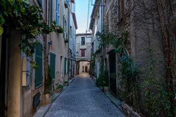 Little alley in the medieval village of Antibes in a sunny winter day