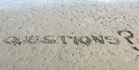 Text QUESTIONS written on the sand