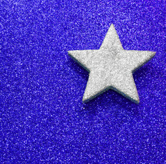 large silver star on blue bright background