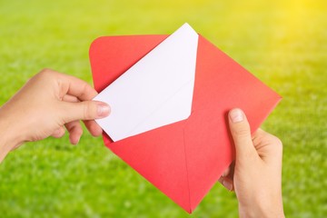 Envelope with Greeting Card in hands isolated on white