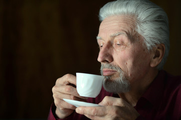 Portrait of senior man drinking