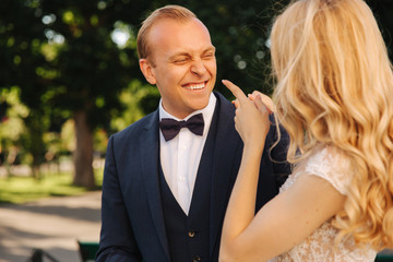 Groom smile to his bride and hud her. Just Married couple