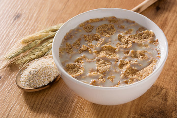 Oats milk and cereals on wooden table. 