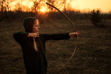 girl with bow in the forest