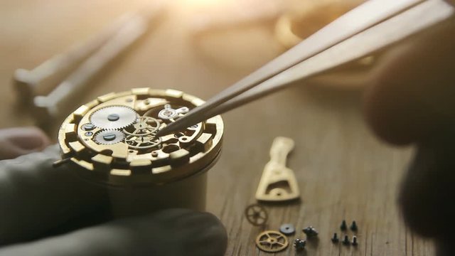 Watchmaker is repairing the wristwatch, mechanical watch, sunlight
