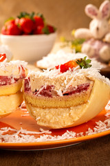 Gourmet easter egg, stuffed with coconut cream, strawberry and chocolate. Easter egg with pudding cream, Easter dessert. Easter concept.