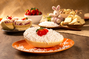 Gourmet easter egg, stuffed with coconut cream, strawberry and chocolate. Easter egg with pudding cream, Easter dessert. Easter concept.