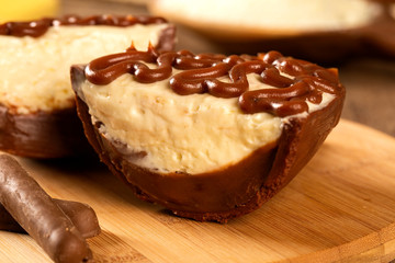 Gourmet easter egg, stuffed with cream and chocolate. Easter egg with pudding cream, Easter dessert. Easter concept.