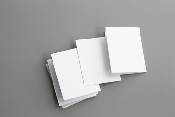 Naklejka premium Blank portrait mock-up paper. brochure magazine isolated on gray, changeable background / white paper isolated on gray