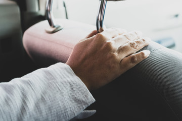 Close-up Of Female's Hand holding car seat Inside Car