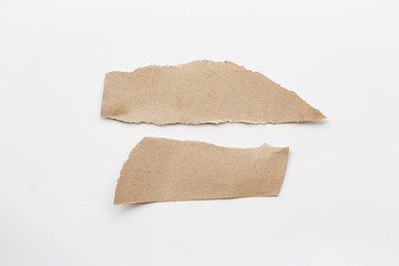 Brown corrugated texture paper torn on white background. rip of cardboard sheet used as a background .