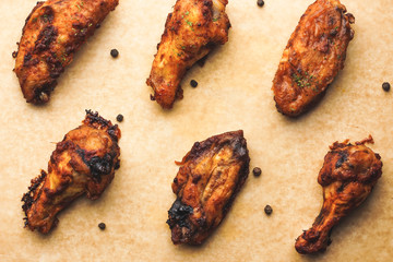 Chicken wings and spices on brown parchment paper