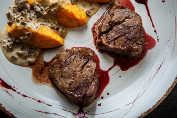 top view macro grilled meat steak with blood with potato zrazy