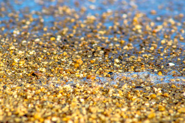 Sand and waves in beach with selective focus