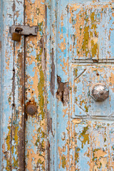 Detail of a beautiful old, light blue painted, weathered, locked door at Rabat Malta