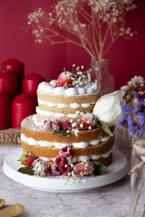 White cake Decorated with flower and berries. For celebrate party weddings, birthdays and events.