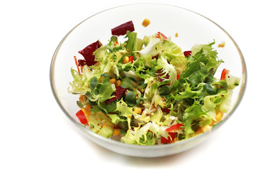 fresh salad in a glass bowl. Salad. Organic food. Healthy vegetable salad with escarole endive, frisee endive, chicory radicchio, lettuce in a glass bowl. Vegetarian food.