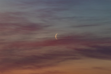 moon and clouds at sunrise