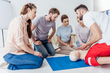 instructor gesturing during first aid training with group of people