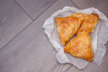 Indian, Asian food delicious samsa or samoses on wooden background. Top view, flat lay. Copy space.