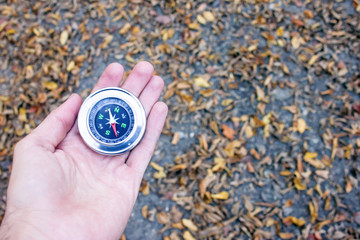 young man hand compass