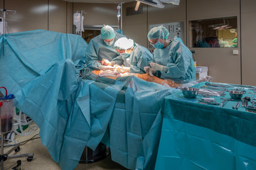 two surgeons perform a vascular operation