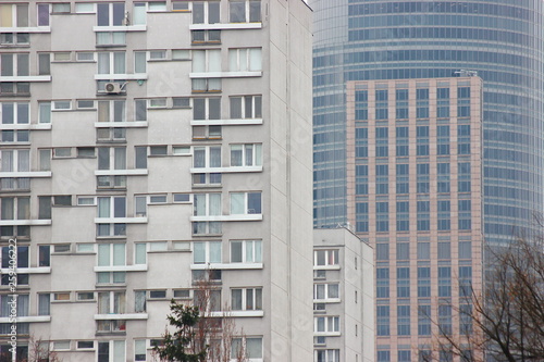 White Plastic Windows Of An Apartment Building Symmetrical Frames White Plastic Windows Of An Apartment Building Symmetrical Frames In A Gray House Many Rooms One Modern Housing Construction Old