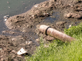 Concrete pipe discharges sewage into Pinheiros River in Sao Paulo city