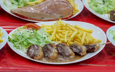 French lunch with fries and beef skewers