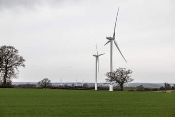 Fototapeta na wymiar Twin Power / An image of two wind turbines shot on a wind farm in the countryside of Leicestershire, England, UK.