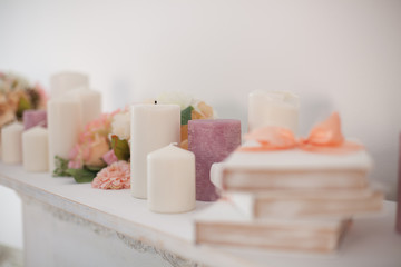 Fototapeta na wymiar spa candles on white background with colorful flowers