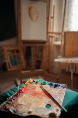 Color palette and brush, easel on background