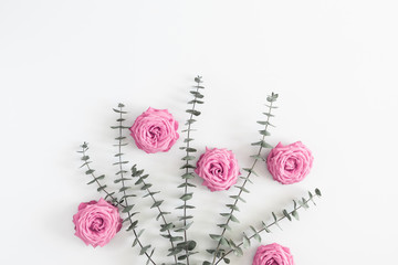 Beautiful flowers composition. Eucalyptus leaves and branches, pink rose flowers on white background. Valentines Day, Easter, Birthday, Happy Women's Day, Mother's day. Flat lay, top view, copy space