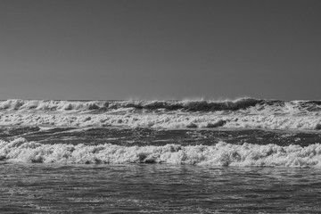 Black and white monochrome image of breaking ocean waves