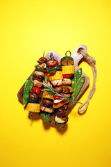 Assorted delicious grilled meat and skewer with vegetable on rustic table
