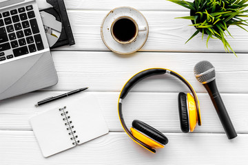 blogger, journalist or musician office desk with computer keyboard, notebook, microphone and headphones on white background top view copyspace