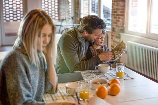 Family sitting at dining table in home